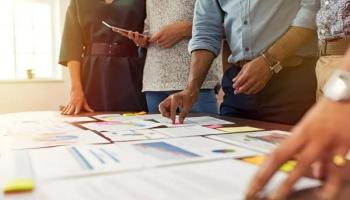 Equipo de inversores analizan gráficas de indicadores económicos